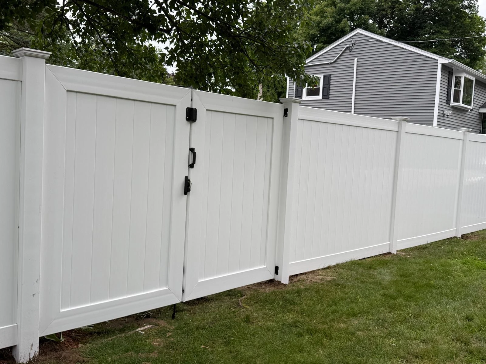 White vinyl privacy fence and double gate — fence options for Salem and Southern NH