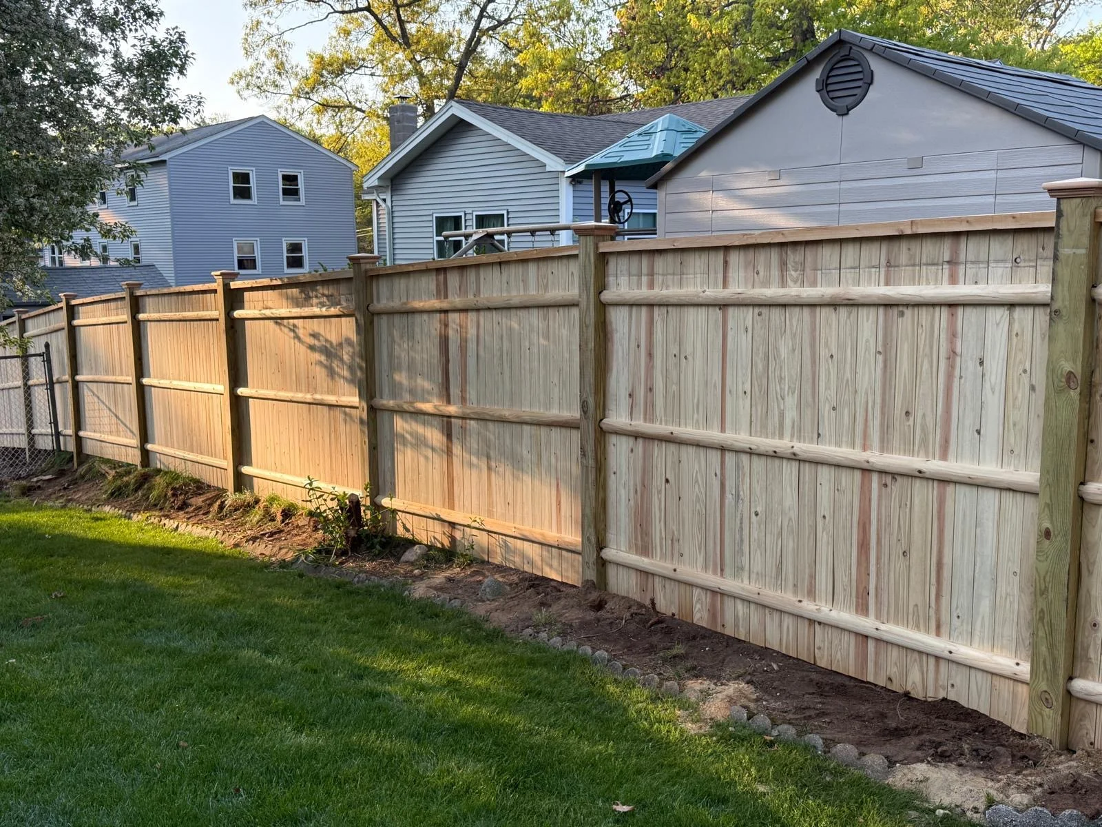 Natural wood privacy fence with horizontal rails — fence options for Salem and Southern NH